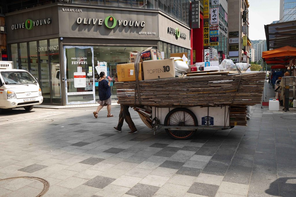 One of the many people collecting cardboard and scrap